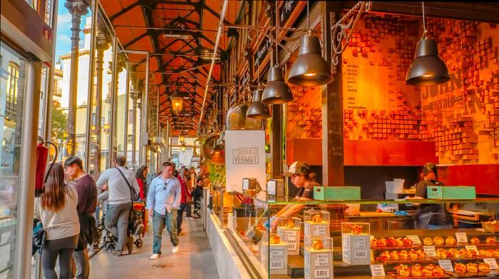 A bustling market hall filled with visitors exploring various food stalls