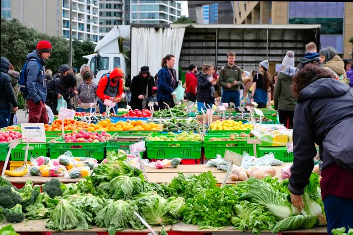 Shoppers at a weekend fruit and vegetable market in Wellington, the capital city of NZ Aotearoa