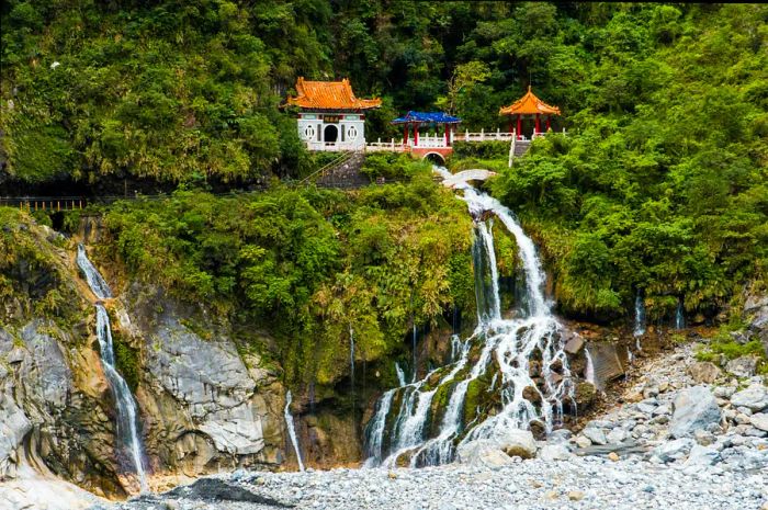 A temple perched in the mountains above a gorge, built over rushing waters