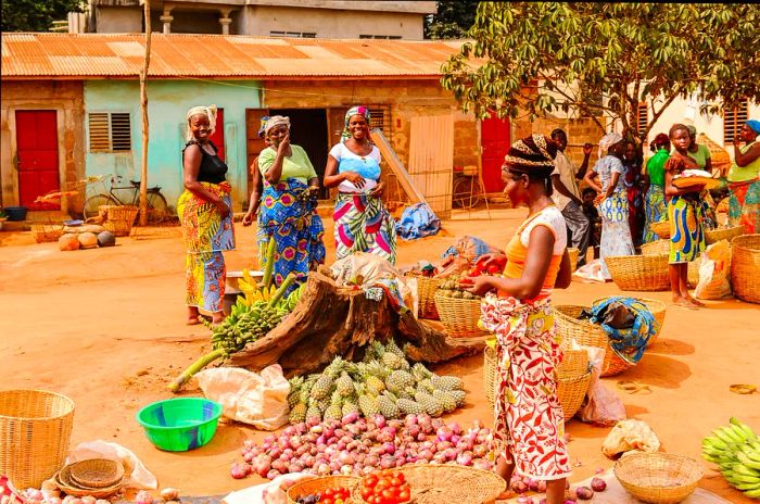 Beninese woman selling produce at a local market