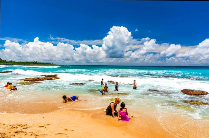 Visitors enjoying the stunning Baishawan coastal reef and waves at Kenting National Park in Pingtung, Taiwan