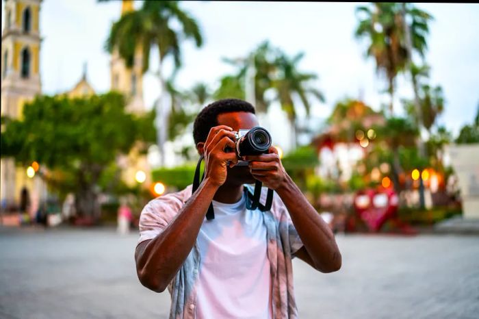 A man captures a photo in a historic plaza