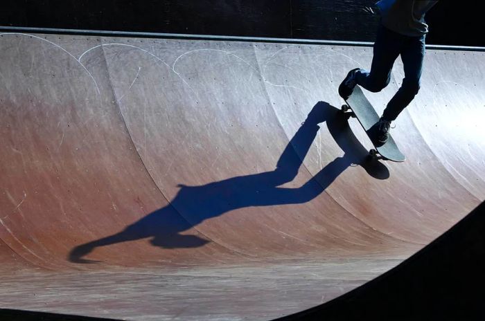 A young male skateboarder enjoying the skate ramp in Auckland.