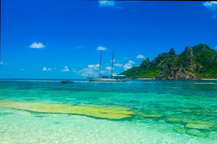 Fiji, Mamanuca Islands, Monuriki, clear blue waters, and a boat