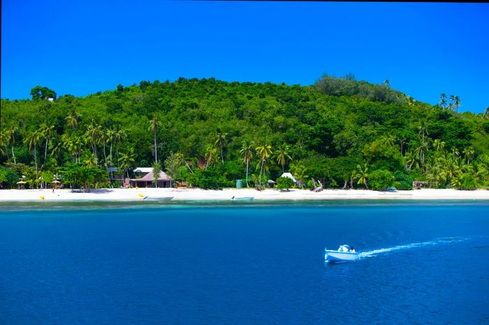 A water taxi glides over the turquoise waters surrounding the Yasawa Islands.