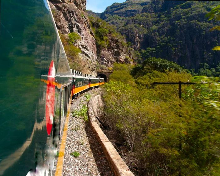 A glimpse of train carriages as they navigate the winding paths of the Copper Canyon Railway.