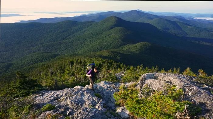 A hiker traverses the rocky terrain of the Long Trail, Mt. Mansfield, Vermont