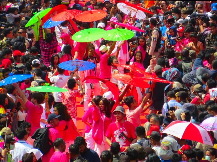 Carnival crowds adorned with vibrant parasols in Glodok, Jakarta's Chinatown