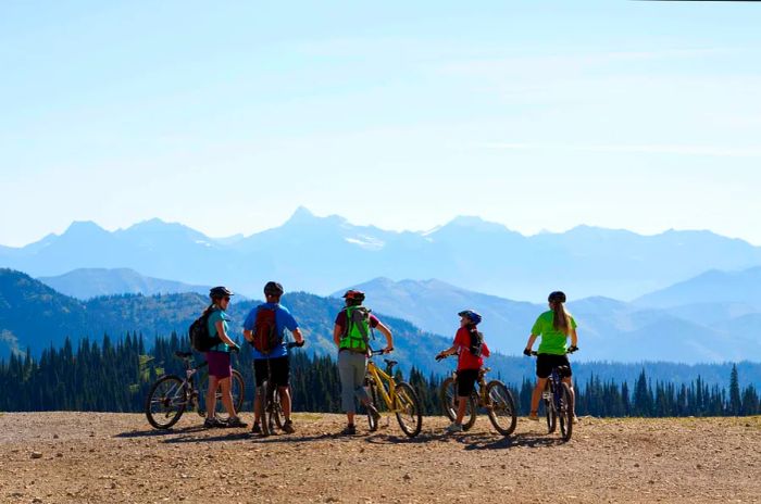 A family poses with bikes in Whitefish, Montana during the summer months.