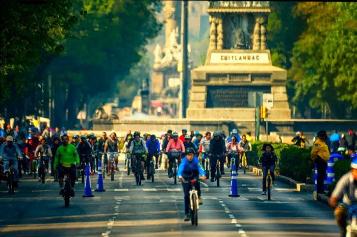 People cycling along Reforma Avenue in Mexico City.