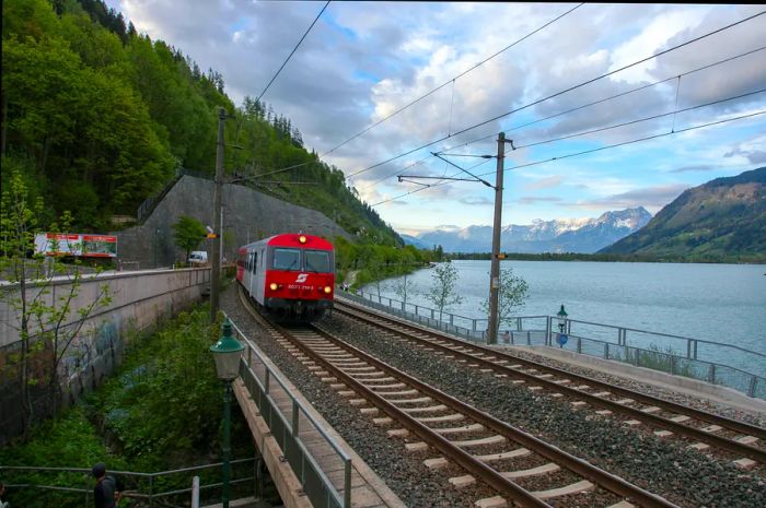 A train glides past the lake in Zell am See, Austria