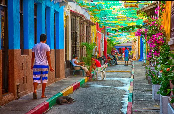 In the vibrant streets of Cartagena's Getsemani neighborhood, locals come together in the late afternoon.