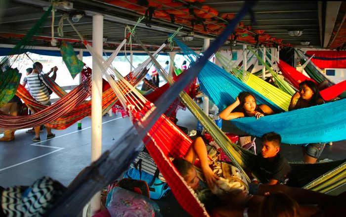 Travelers relax in their hammocks as they embark on a transport riverboat from Manaus to Maues, Brazil.