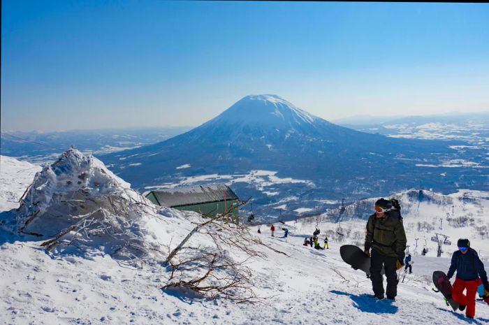 Snowboarders trek up the backcountry trail at Mt. Annupuri