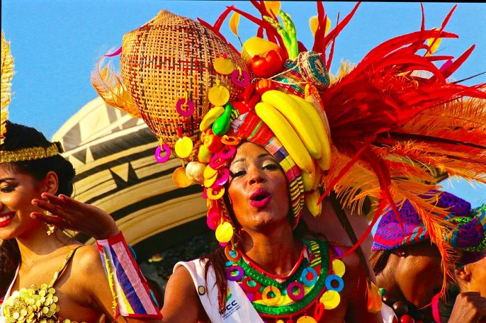 A woman in a vibrant outfit enjoys the atmosphere in Cartagena, Colombia.