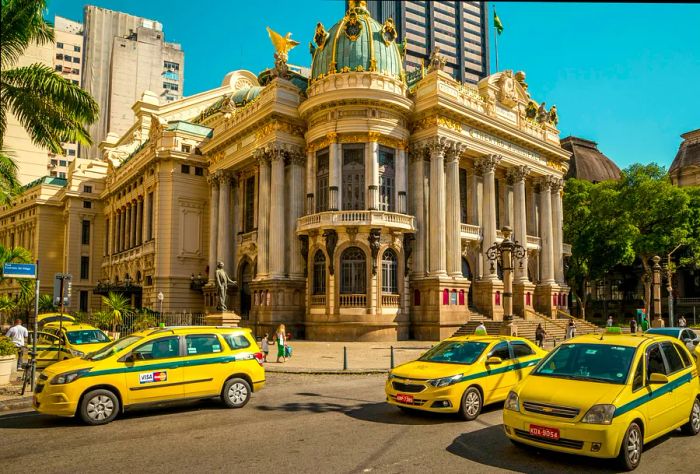 A street bustling with taxis, featuring Theatro Municipal in the background, Rio de Janeiro, Brazil