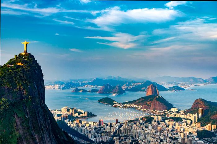 Aerial view of Rio de Janeiro featuring Christ the Redeemer atop Corcovado Mountain, Sugarloaf Mountain, and Guanabara Bay