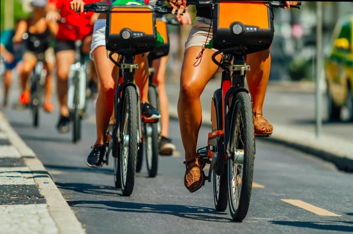 A group of cyclists ride along a bike path in the Copacabana area (Rio de Janeiro, Brazil)