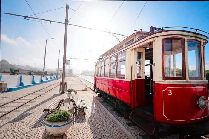 A red and white tram in Portugal stands still, ready to welcome passengers