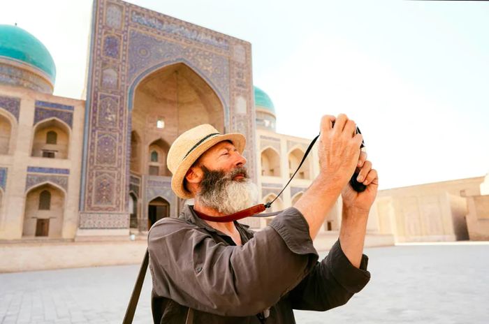 A person photographing architectural features