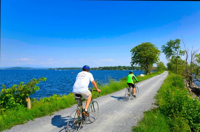 Cyclists traverse the Colchester Causeway on Lake Champlain in Vermont.