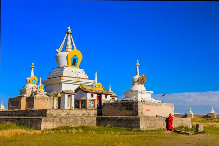 A monk beside the stupa at Erdene Zuu Monastery in Kharkhorin, Mongolia