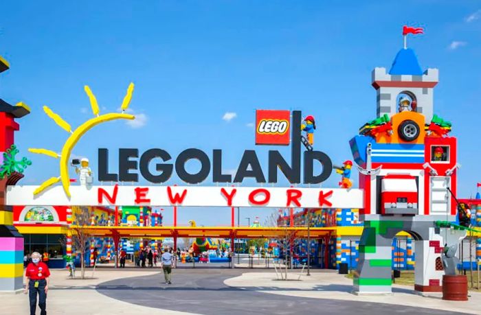 Guests walk through the vibrant entrance gate to Legoland in New York