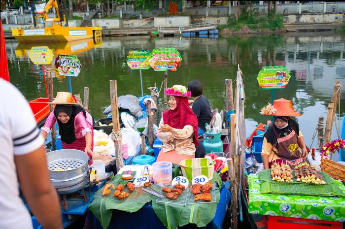 Vendors at the Khlong Hae floating market in Songkhla, Thailand