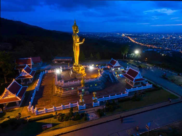 Aerial night view of a Buddha statue perched on a mountain in Hat Yai, Songkhla, Thailand