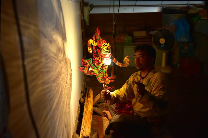 A performer showcases traditional Nang Talung shadow puppetry in Thailand