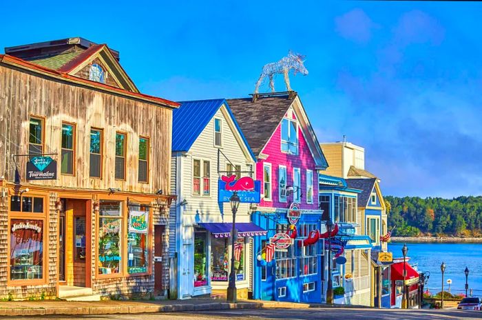 Vibrant wooden storefronts adorned with lobster signs in Bar Harbor, Maine.