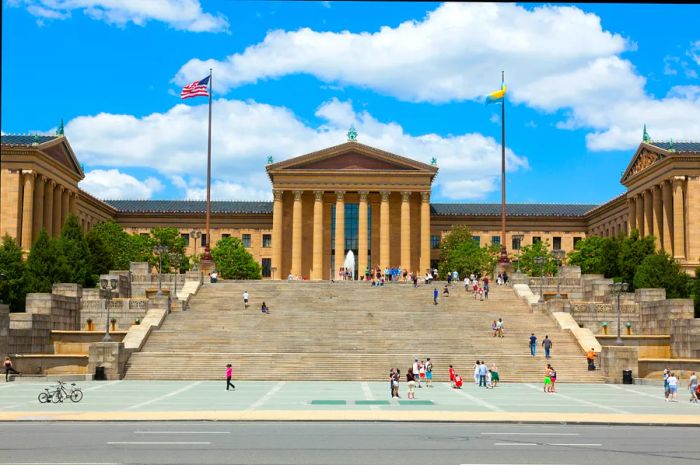 Visitors relaxing and walking up the steps of the Philadelphia Museum of Art, famously featured in the Rocky film