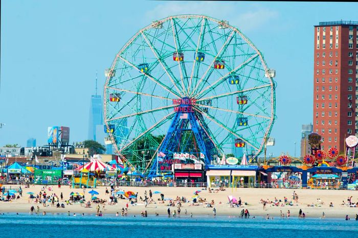 The iconic Wonder Wheel and the lively beach at Coney Island, New York, as viewed from the water.