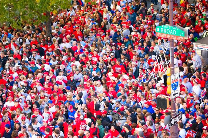 Fans of the Philadelphia Phillies, mostly dressed in red, gather in celebration after winning the World Series