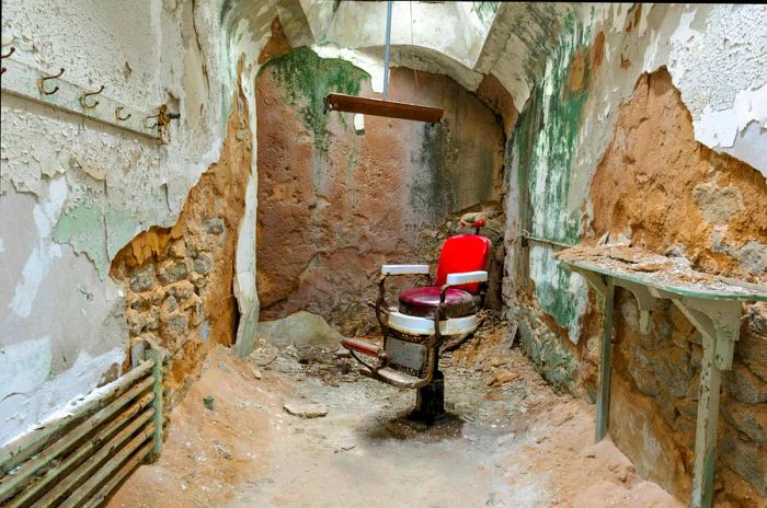 A barber chair resides in a crumbling prison cell at Eastern State Penitentiary in Philadelphia