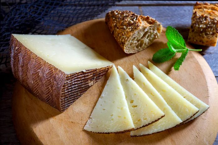 A selection of Spanish cheese paired with a loaf of bread