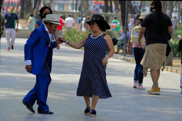 An elderly couple dances in the streets of Alameda Central in Mexico City, Mexico