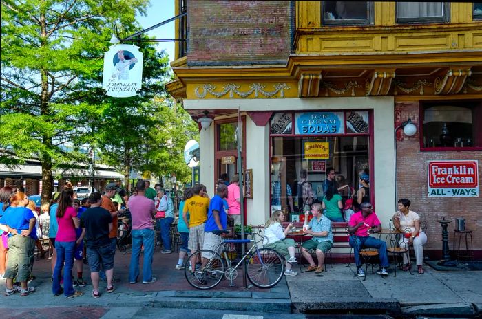 A bustling crowd gathers outside the popular Franklin Fountain, a beloved ice cream shop in Philadelphia.