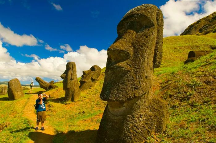 A teenager captures a photo of a massive rock formation resembling a head