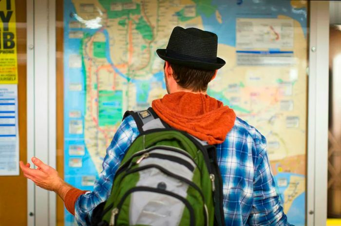 A person examining a public transport map in New York City