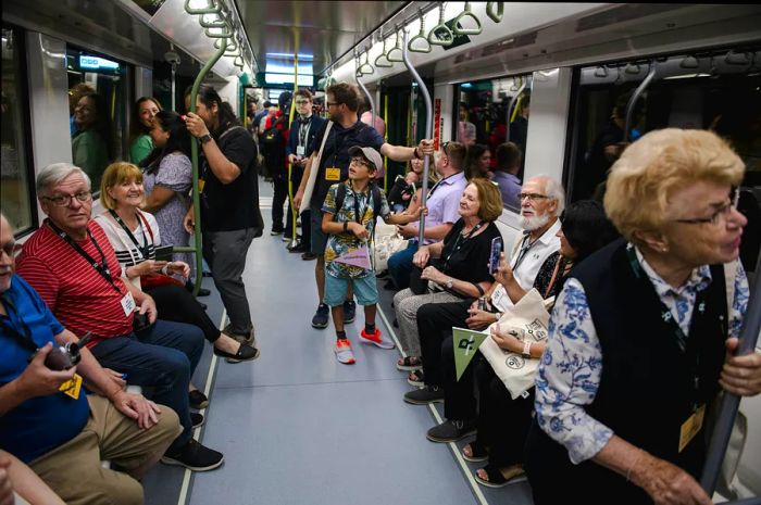 Tourists take a ride on the Reseau Express Metropolitain (REM) light rail in Montréal, Québec, Canada