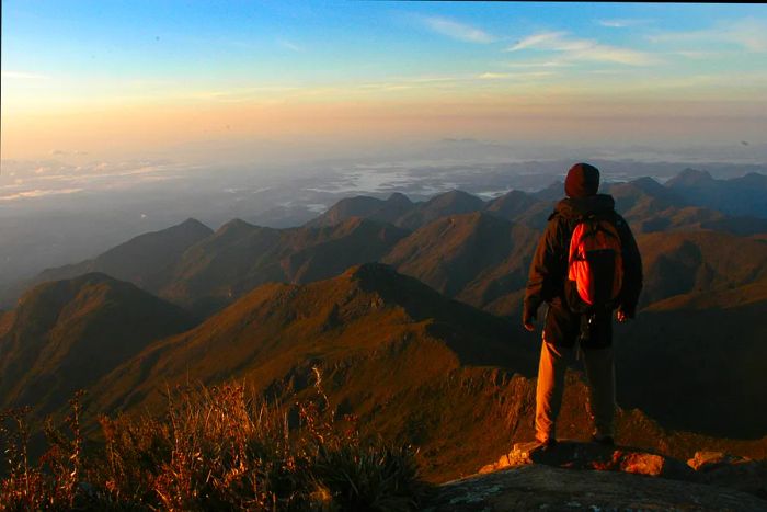 Hiker at the summit of Pico da Bandeira, Brazil