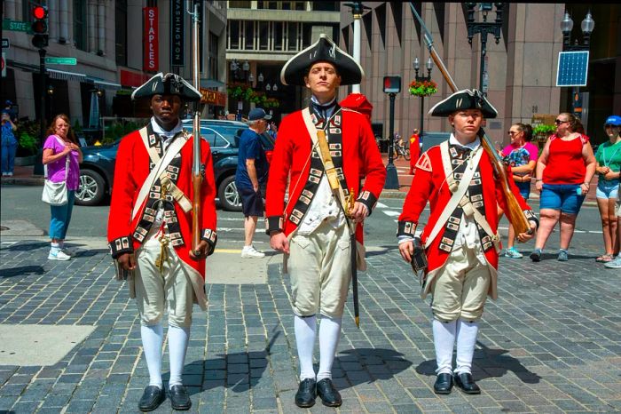 Re-enactors dressed as Redcoat soldiers at The Old State House, Boston, Massachusetts, USA