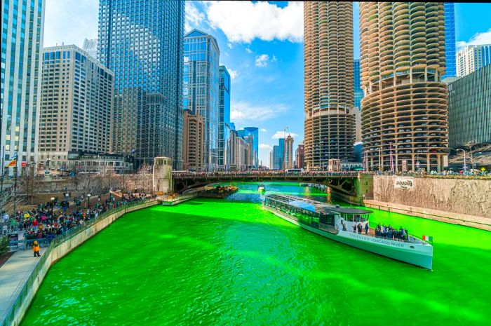 A boat on the Chicago River, transformed with green dye for St. Patrick’s Day, Chicago, Illinois, USA