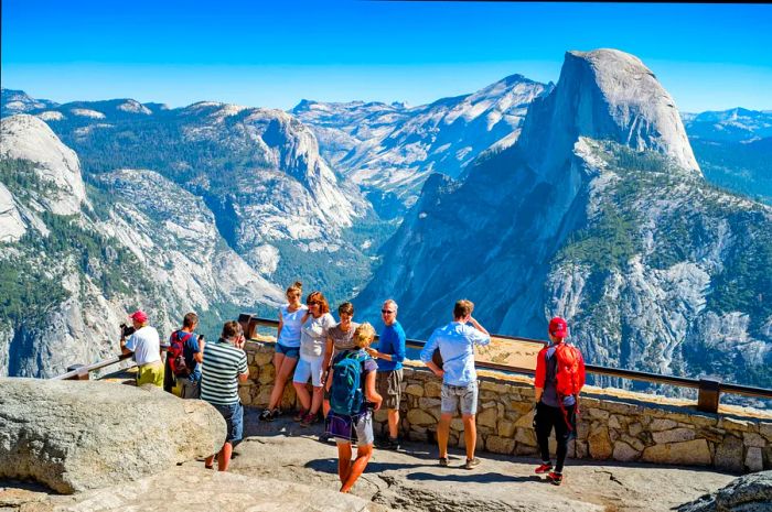 Visitors take in the breathtaking view from Glacier Point in Yosemite National Park, California