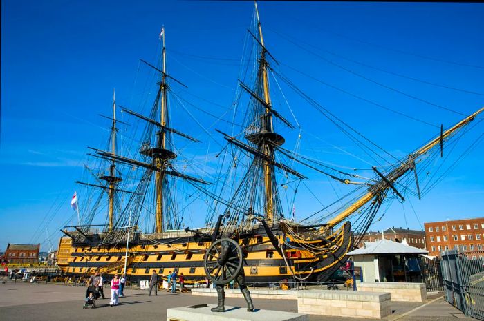 Visitors gather in front of the three-masted HMS Victory in Portsmouth, Hampshire, England