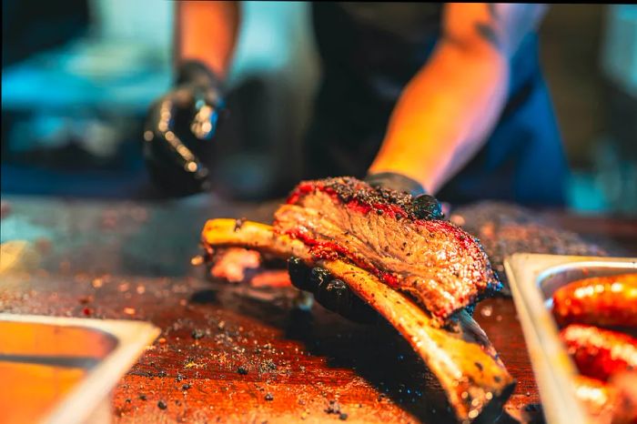 A Texas BBQ chef showcasing a portion of smoked brisket