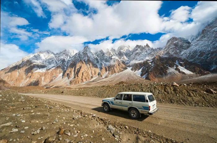 A 4WD navigating an empty stretch of the Karakoram Highway