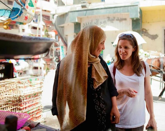 Two women chatting at a market in Egypt