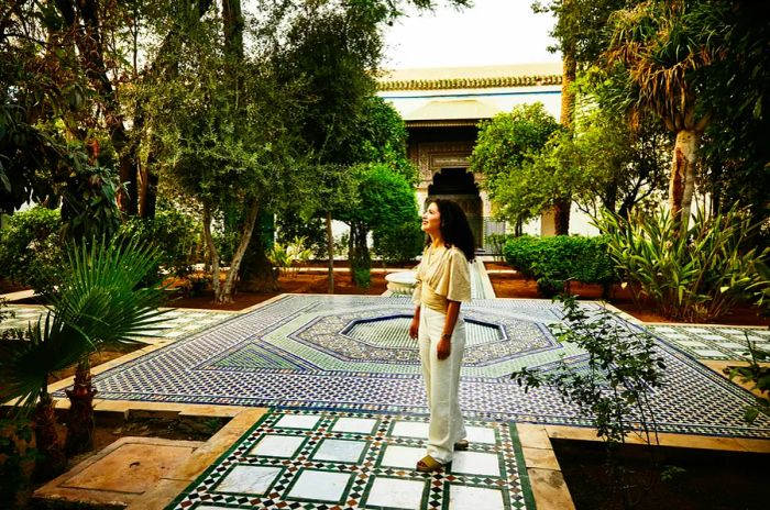 A woman beams as she admires a courtyard adorned with intricate tiles